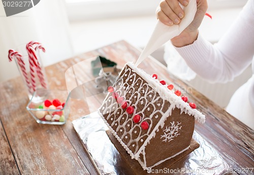 Image of close up of woman making gingerbread houses