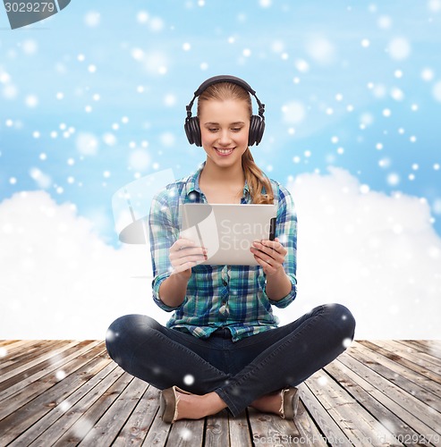 Image of happy young woman with tablet pc and headphones