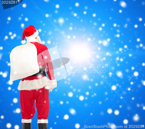 Image of man in costume of santa claus with bag
