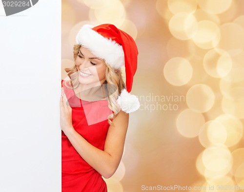 Image of smiling young woman in santa hat with white board