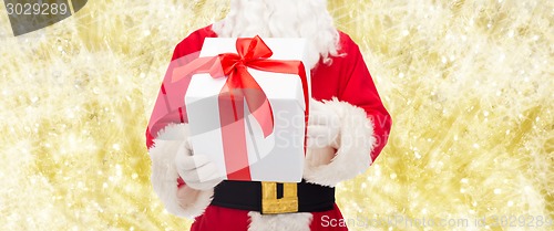 Image of man in costume of santa claus with gift box