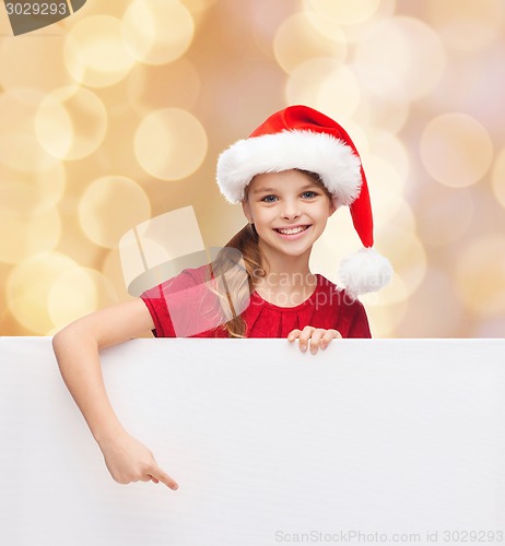 Image of girl in santa helper hat with blank white board