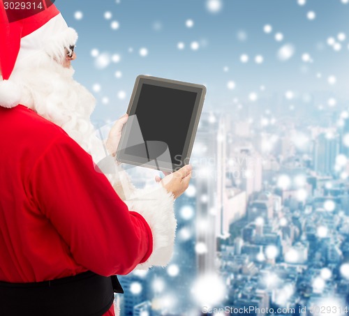 Image of man in costume of santa claus with tablet pc