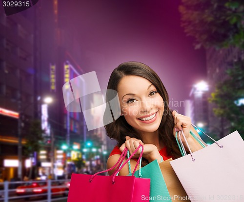 Image of smiling young woman with shopping bags