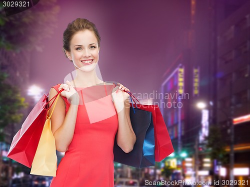 Image of smiling young woman with shopping bags