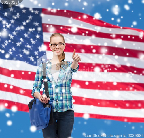 Image of smiling girl in casual clothes showing thumbs up