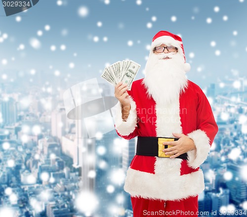 Image of man in costume of santa claus with dollar money