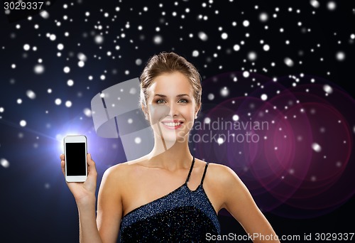 Image of smiling woman in evening dress with smartphone