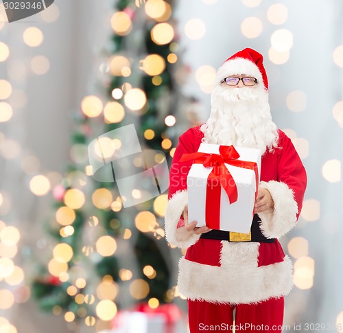 Image of man in costume of santa claus with gift box