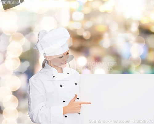 Image of smiling female chef with white blank board