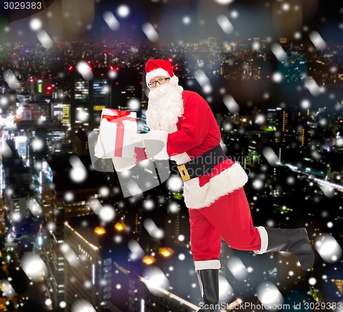 Image of man in costume of santa claus with gift box