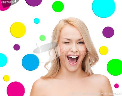 Image of beautiful young woman over polka dot background