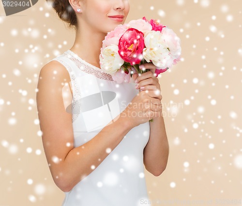 Image of close up of woman in white dress with flowers