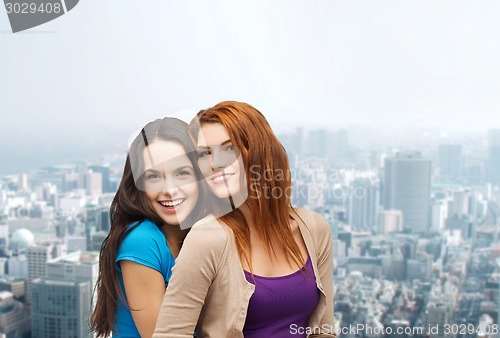 Image of smiling teenage girls hugging