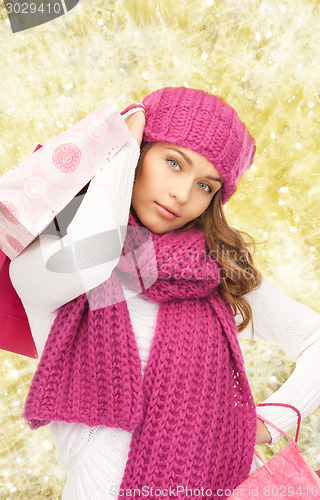 Image of smiling young woman with shopping bags