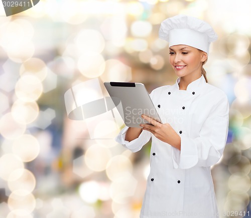 Image of smiling female chef with tablet pc computer