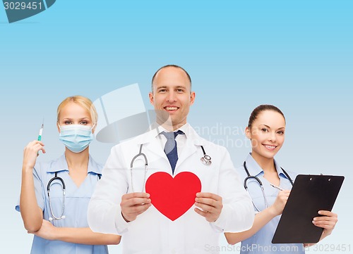 Image of group of smiling doctors with red heart shape