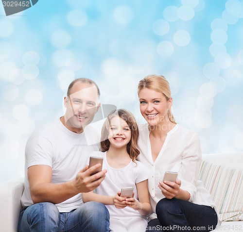 Image of happy family with smartphones