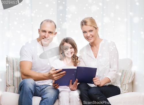 Image of happy family with book at home