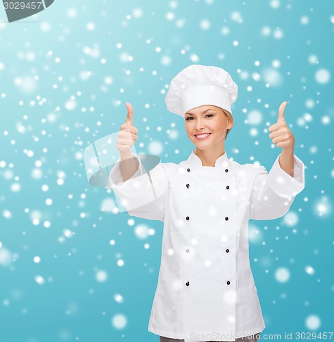 Image of smiling female chef showing thumps up