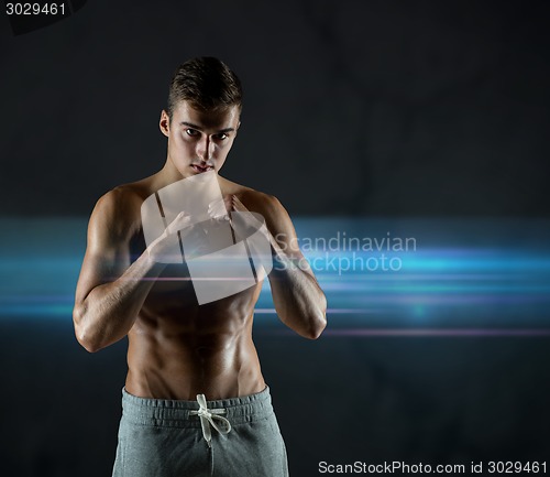 Image of young man in fighting or boxing position