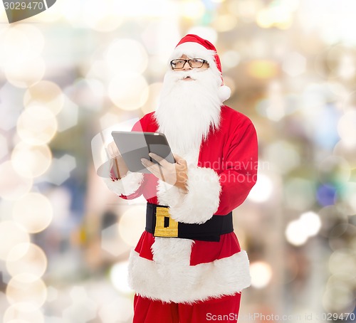 Image of man in costume of santa claus with tablet pc