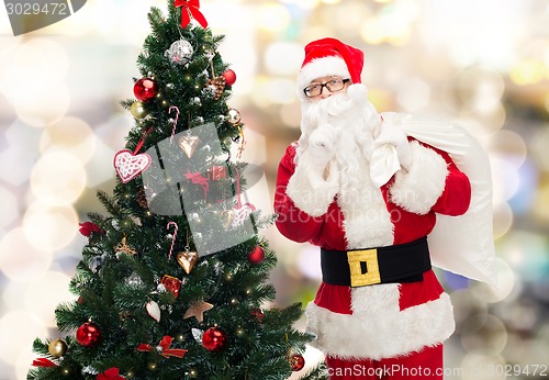 Image of santa claus with bag and christmas tree