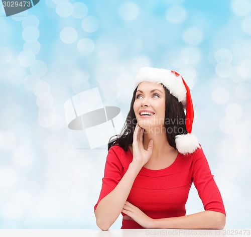 Image of smiling woman in santa helper hat