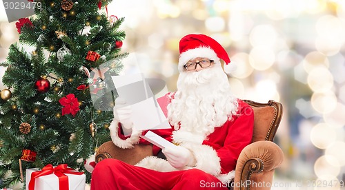 Image of man in costume of santa claus with letter