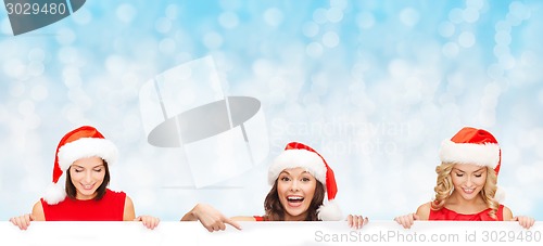Image of women in santa helper hat with blank white board