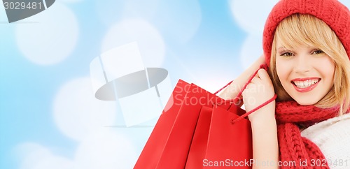 Image of smiling young woman with shopping bags
