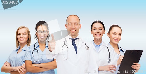 Image of group of smiling doctors with showing thumbs up