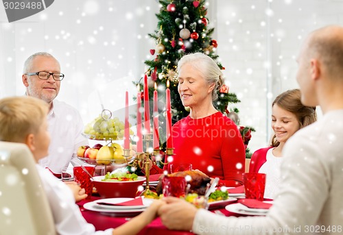 Image of smiling family having holiday dinner at home