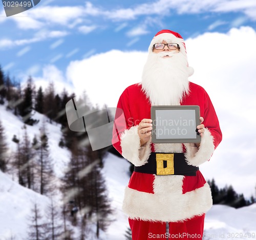 Image of man in costume of santa claus with tablet pc