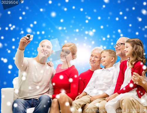 Image of smiling family with camera