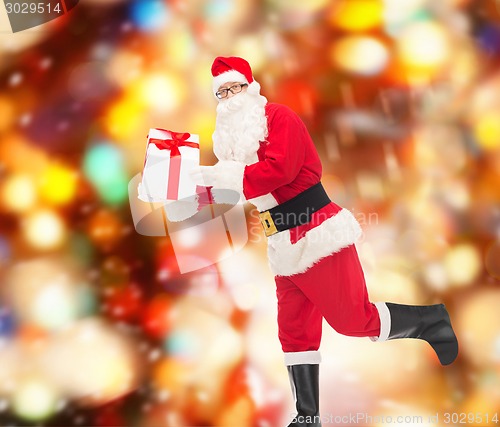 Image of man in costume of santa claus with gift box