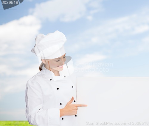 Image of smiling female chef with white blank board