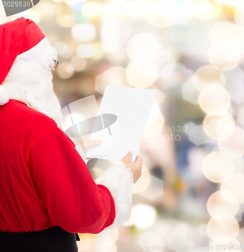 Image of man in costume of santa claus with letter