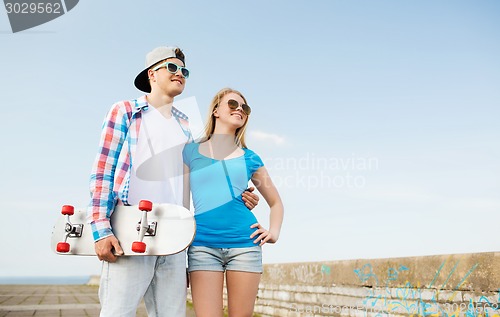 Image of smiling couple having fun outdoors