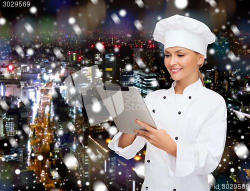 Image of smiling female chef with tablet pc computer