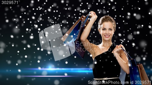 Image of smiling woman in dress with shopping bags