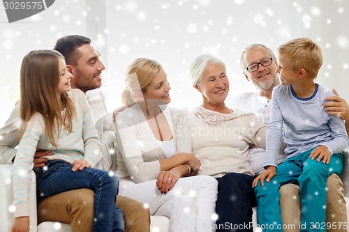 Image of happy family sitting on couch at home