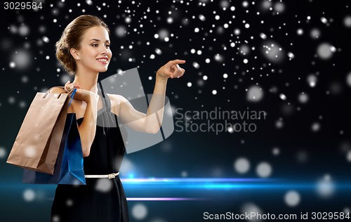 Image of smiling woman in dress with shopping bags