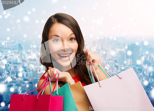 Image of smiling woman with colorful shopping bags