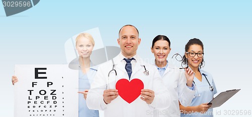 Image of group of smiling doctors with red heart shape