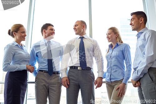 Image of smiling businesspeople meeting in office