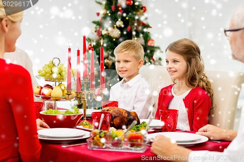 Image of smiling family having holiday dinner at home