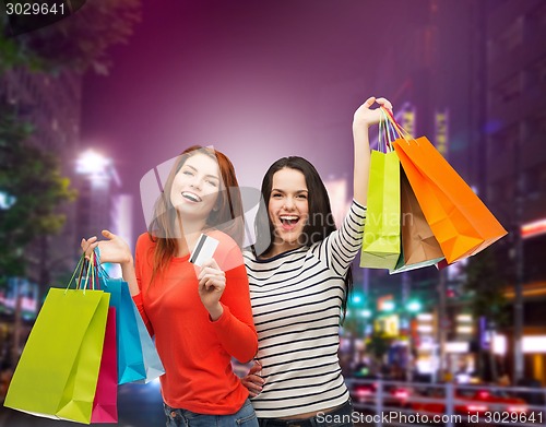 Image of two smiling teenage girls with shopping bags