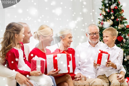 Image of smiling family with gifts at home