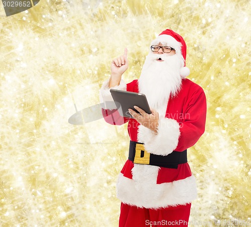 Image of man in costume of santa claus with tablet pc